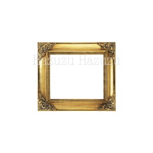May include: A gold-colored picture frame with ornate detailing around the edges. The frame is empty.