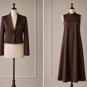 May include: A dark brown cropped blazer with long sleeves, a notched lapel, and a single button closure, displayed alongside a dark brown sleeveless midi dress featuring a high mock neck and a flared, A-line silhouette on a mannequin.