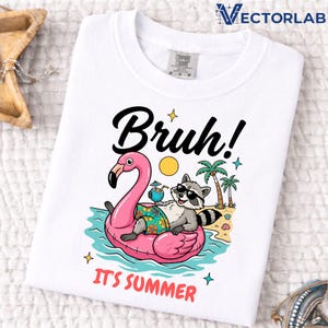 May include: White t-shirt with a graphic of a raccoon wearing sunglasses, relaxing on a pink flamingo float in the ocean. The text "Bruh! It's Summer" is above and below the graphic. The shirt has a Comfort Colors tag.
