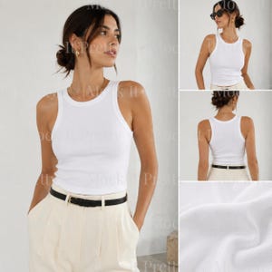 May include: A white ribbed tank top with a classic crew neck and a fitted silhouette. The tank top is paired with cream-colored pleated pants and a black belt. The image shows the tank top from multiple angles, highlighting its simple design.