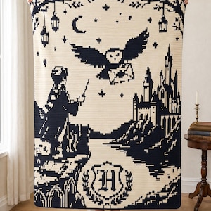 May include: A cream and dark blue crochet blanket featuring a pixelated design of a figure holding a wand, an owl carrying a letter, a castle, hanging lanterns, stars, a crescent moon, and a central crest with the letter H.