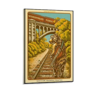 May include: A rectangular concert poster featuring a brown bear walking along railroad tracks while carrying a guitar. Above, a train bridge displays the text WIDESPREAD PANIC. The scene includes green trees, a blue sky, and the text September 12-13, 2005.