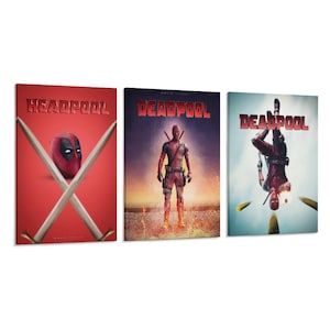 May include: A triptych of canvas prints featuring the character Deadpool. The first print reads "HEADPOOL" with crossed swords and a Deadpool mask. The second print shows Deadpool standing. The third print shows Deadpool upside down.
