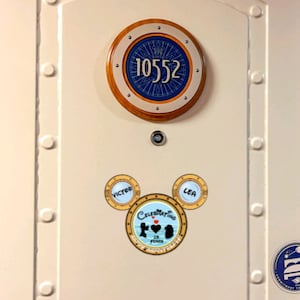 This is an anniversary magnet for disney lovers! It is a silhouette of disney characters and one name in each ear and the words happy anniversary at the bottom.