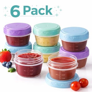 May include: Six-pack of clear food storage containers with colorful lids. The containers are filled with various foods, including a red sauce and a yellow puree. Each container has measurement markings. The lids are purple, blue, and green.