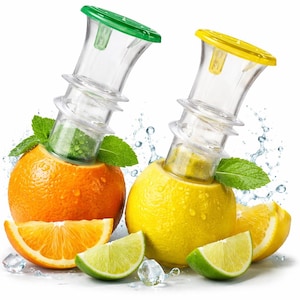 May include: Two clear citrus juicers with green and yellow tops are inserted into an orange and a lemon. Slices of orange and lime are arranged around the fruit, with mint leaves and water droplets. The juicers have a spiral design.
