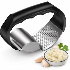 May include: A black and silver garlic press with a curved design and a handle. The press is shown with a bowl of minced garlic, garlic cloves, and parsley.
