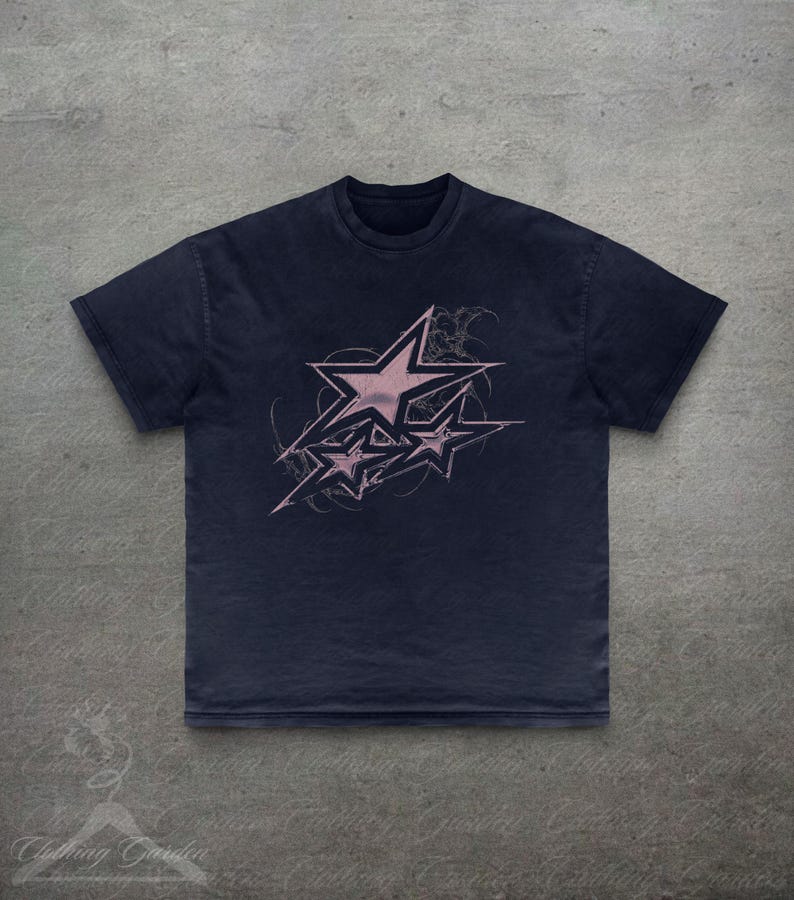 Op de afbeelding: Marineblau T-shirt met een roze sterrenontwerp. De afbeelding toont meerdere sterren met een distressed, grunge stijl. De tee heeft een ronde hals en korte mouwen, ideaal voor dagelijks gebruik. Het shirt is gemaakt van zacht materiaal.