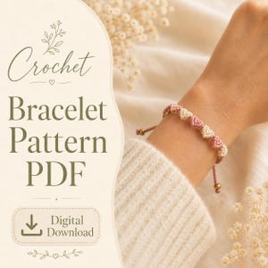May include: A crochet bracelet featuring alternating small cream and dusty pink heart-shaped knots on a thin cord with adjustable sliding beads. The image includes text that reads Crochet Bracelet Pattern PDF and Digital Download.