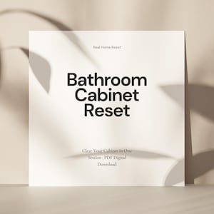 Puede incluir: Una tarjeta blanca con el texto "Bathroom Cabinet Reset" en letras negras en negrita. La tarjeta también incluye el texto "Real Home Reset" y "Clear Your Cabinet in One Session - PDF Digital Download."