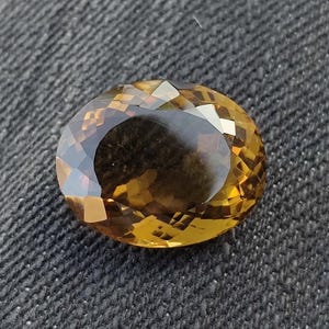 Natural 10.35 carat oval cut brown quartz gemstone with precision faceted surface and warm amber-brown color.
Luxury faceted brown quartz loose gemstone displaying brilliant sparkle and elegant oval shape.
High clarity natural brown quartz jewelry stone featuring rich earthy tones and polished facets.
Oval cut luxury quartz gemstone for jewelry making with reflective faceting and premium finish.
Natural brown quartz gemstone ideal for rings and pendants showcasing warm color, clarity, and