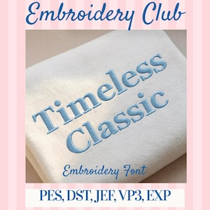 May include: A light-coloured fabric with the words "Timeless Classic" embroidered in light blue. The text "Embroidery Club" and "Embroidery Font" are also visible. The image is set against a pink and white striped background.