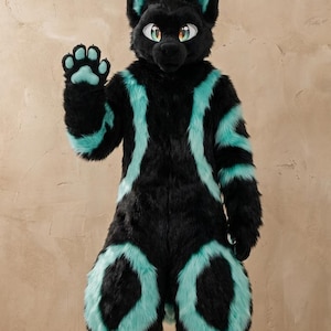 May include: A full-body animal costume featuring black faux fur with vibrant teal accents on the ears, chest, arms, and legs. The head has large, expressive eyes with teal irises, and the hand paws feature teal paw pads on a black base.