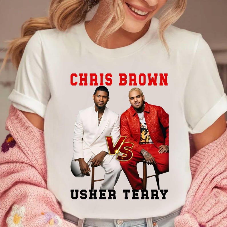 May include: White t-shirt featuring the text "CHRIS BROWN" in red block letters above images of two men. The text "USHER TERRY" is below the images. The men are seated, one in a white suit and the other in a red outfit. A gold "Vs" graphic is between them.