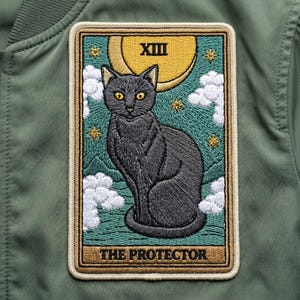 May include: Embroidered patch featuring a black cat with yellow eyes, a crescent moon, and stars. The patch has the Roman numeral XIII and the words "THE PROTECTOR" on a teal background with white clouds.
