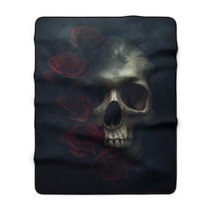 May include: A black blanket featuring a detailed illustration of a human skull with red roses. The skull is in the center, with roses on the left side. The background is dark and smoky.