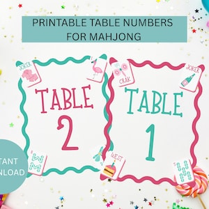 May include: Printable table numbers for Mahjong. The design features two cards with the word "TABLE" and numbers 1 and 2. Each card has a pink border with a teal wavy outline. The image includes the text "INSTANT DOWNLOAD".