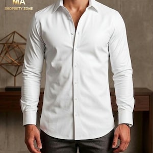 May include: A white button-down shirt with long sleeves. The shirt has a classic collar and is buttoned up the front. The image also shows the text "MA SHOPINITY ZONE" in the upper left corner.