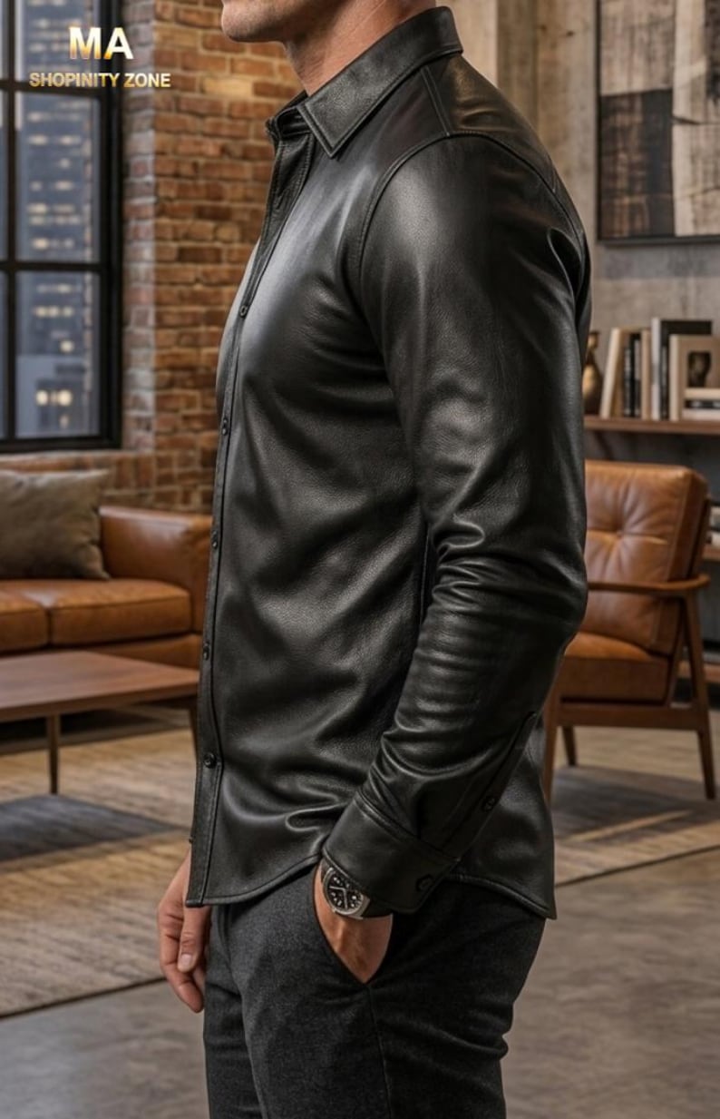 May include: Black leather button-down shirt with long sleeves. The shirt has a classic collar and buttoned cuffs. The image also shows a watch on the wrist and the text "SHOPINITY ZONE".