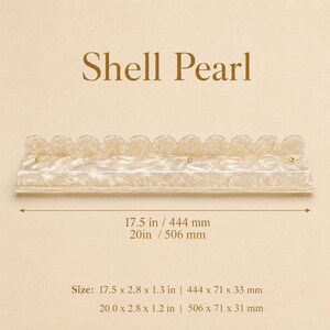 May include: A decorative shelf with a scalloped edge, made of a pearlescent material. The shelf is approximately 17.5 inches long and features gold-colored accents. The text "Shell Pearl" is displayed above the shelf.