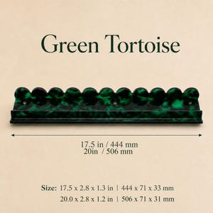 May include: A green tortoise-shell style rack with a series of circular holders. The rack is 17.5 inches long and 2.8 inches wide. The text "Green Tortoise" is above the rack.
