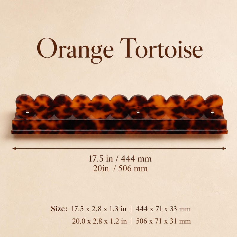 May include: An orange tortoise-shell shelf with a scalloped top edge. The shelf is 17.5 inches long and 2.8 inches wide. The text "Orange Tortoise" is above the shelf.
