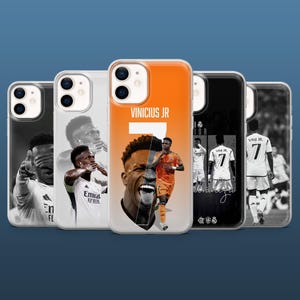 May include: A collection of phone cases featuring images of a soccer player. The cases have a variety of designs, including portraits, action shots, and the player's name and number. The cases are in various colors, including white, black, and orange.