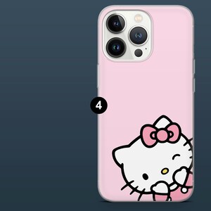 May include: Pink phone case featuring a Hello Kitty design. The case has a clear border and a smooth surface. The Hello Kitty graphic is white with a pink bow and accents. The phone case is designed to fit a smartphone.