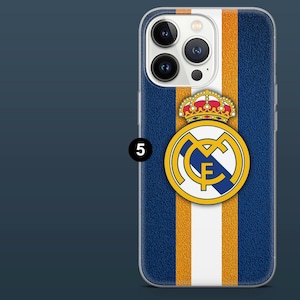 May include: A blue phone case with a white and orange vertical stripe design. The case features a gold and white emblem with a crown and the number 5. The case is designed for a smartphone.