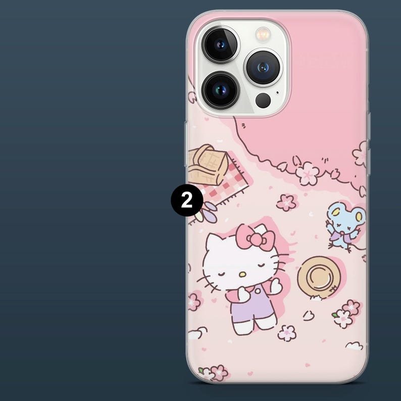 May include: Pink phone case featuring a cartoon picnic scene with Hello Kitty, a mouse, flowers, and a picnic basket. The case has a clear border and a glossy finish.