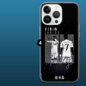 May include: Black phone case featuring a graphic of a soccer player in a white jersey with the number 7. The case includes the text "VINI JR" and the word "Malvadeza" in a script font.