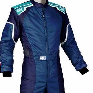 May include: A blue and dark blue racing suit featuring a high collar, a central zipper, and teal shoulder panels with white OMP branding. The long-sleeved garment includes white piping accents along the shoulders and arms, with black cuffs at the wrists.