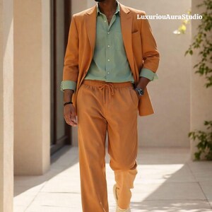 May include: A stylish ensemble featuring an orange blazer, matching drawstring pants, and a light green button-down shirt. The outfit is completed with white sneakers and sunglasses. The text "LuxuriousAuraStudio" is visible in the image.