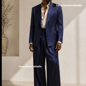May include: A navy blue double-breasted suit with wide-leg trousers. The suit is paired with a light beige dress shirt. The image features the text "LuxuriousAuraStudio".