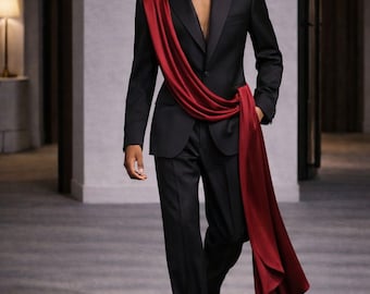 May include: A black suit with a satin lapel and matching trousers. A flowing, deep red sash is draped across the chest. The image includes the text "LuxuriousAuraStudio".