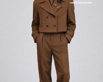 May include: A brown suit featuring a double-breasted jacket with black buttons, matching trousers, and a scarf. A rose-shaped brooch adorns the jacket. The outfit is completed with black shoes and sunglasses. The text "LuxuriousAuraStudio" is visible.