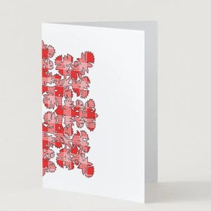 May include: A white folded greeting card featuring a vertical decorative border on the left side. The border consists of a repeating floral or leaf-like pattern filled with a red and white plaid tartan check design against the plain white card.