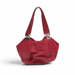 May include: A vibrant red leather handbag featuring a slouchy, rounded silhouette with vertical stitched detailing. The bag includes two shoulder straps attached to the body with polished silver-tone metal hardware and a small horizontal metal bar.