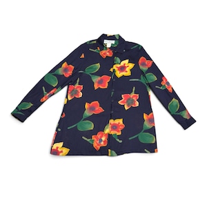 May include: A long-sleeved button-down shirt in a dark navy blue color featuring a repeating floral pattern of red, orange, and yellow flowers with green leaves. The shirt has a standard collar and a front button closure with a white brand label.