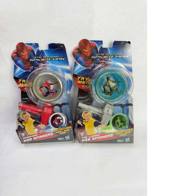 May include: Two Spider-Man Web Spinners toys in their original packaging. Each package features a clear plastic window showcasing the toy's design. The packaging includes the text "The Amazing Spider-Man" and "Web Spinners". One toy features Spider-Man, the other The Lizard.