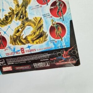 May include: A partially visible action figure package featuring Marvel's Spider-Man characters. The package includes images of Sandman, Venom, and other figures. The text "COLLECT ALL 8 FIGURES TO BUILD SANDMAN" is visible.