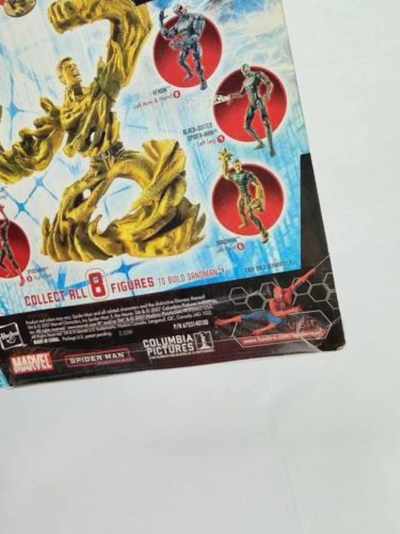 May include: A partially visible action figure package featuring Marvel's Spider-Man characters. The package includes images of Sandman, Venom, and other figures. The text "COLLECT ALL 8 FIGURES TO BUILD SANDMAN" is visible.