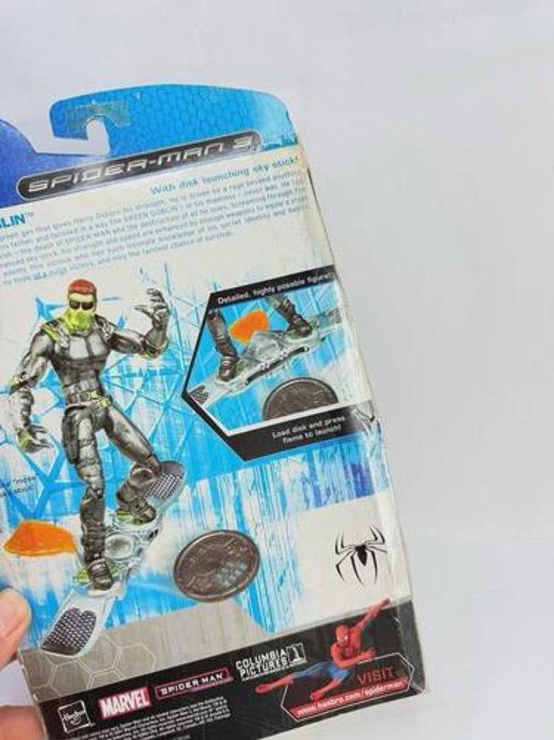 May include: A Spider-Man 3 action figure of the Green Goblin on a sky stick, with a green and silver color scheme. The packaging includes the Marvel and Spider-Man logos, and the text "With disk launching sky stick!"
