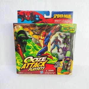 May include: Spider-Man Ooze Attack Playsets box set. The box features Spider-Man and Green Goblin figures. The packaging includes the text "Ooze Attack Playsets" and "Spider-Man vs Green Goblin". The set is for ages 4+.