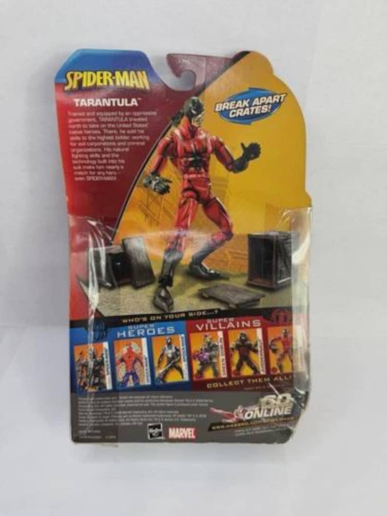 May include: A Spider-Man action figure of the character Tarantula, packaged on a cardboard backing. The figure is red and black, with the words "Spider-Man" and "Tarantula" printed on the packaging. The packaging also includes the text "Break Apart Crates!"