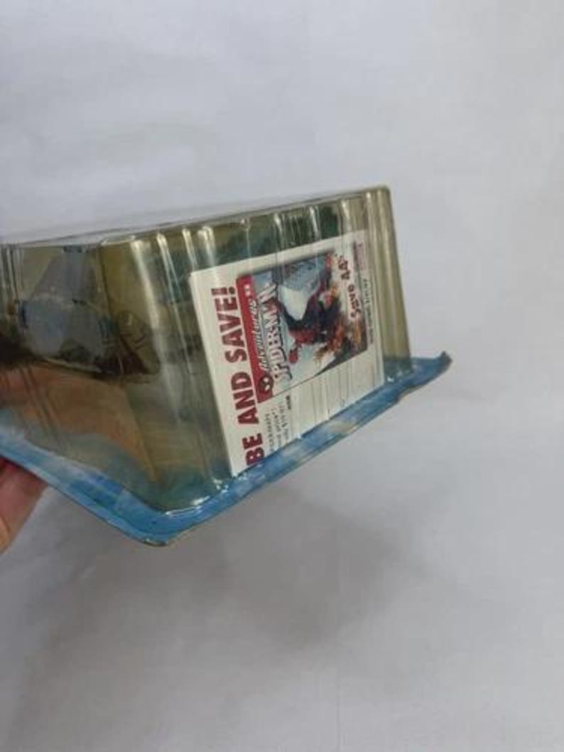May include: Sealed action figure package featuring the Adventures of Spider-Man. The packaging is clear plastic with a blue and white base. The package includes the text "BE AND SAVE!" and a graphic of Spider-Man.