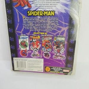 May include: A Spider-Man comic book package with a purple and blue background. The package features the Spider-Man logo and illustrations of Spider-Man and other characters. The text on the package reads "Spider-Man Classics".