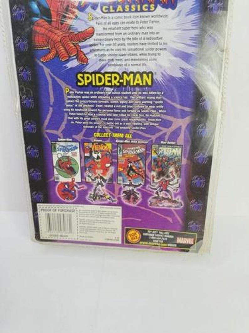May include: A Spider-Man comic book package with a purple and blue background. The package features the Spider-Man logo and illustrations of Spider-Man and other characters. The text on the package reads "Spider-Man Classics".