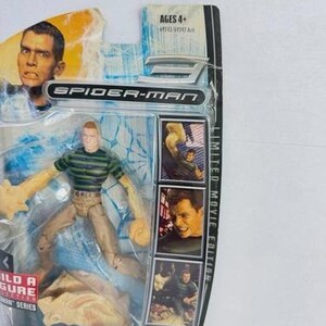May include: Spider-Man Sandman action figure in original packaging. The figure wears a green and black striped shirt and tan trousers. The packaging includes images of the character and the text "Limited Movie Edition". Ages 4+