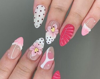 Unhas postiças personalizadas rosa e branca, com estampa de flores 3D e bolinhas, formato amendoado, um conjunto de nail art fofo e divertido.